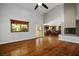 Living room with hardwood floors, fireplace, and large windows providing natural light at 8365 S Hauck St, Las Vegas, NV 89139