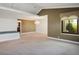 Spacious living room featuring carpet, recessed lights, and a chandelier in an open floor plan at 8365 S Hauck St, Las Vegas, NV 89139