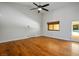 Bright room with hardwood floors, ceiling fan, and access to outdoor pool at 8365 S Hauck St, Las Vegas, NV 89139