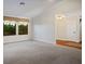 Spacious living room with plush carpeting, neutral walls, and natural light, creating a welcoming ambiance at 8365 S Hauck St, Las Vegas, NV 89139