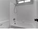 Bathroom showcasing a tiled bathtub and shower combination, offering a clean and modern aesthetic at 887 Cozy Valley St, Henderson, NV 89015