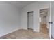 This bedroom features light gray walls, wood-look tile flooring, and a closet at 887 Cozy Valley St, Henderson, NV 89015