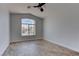 Bright bedroom with a large arched window and wood-look tile flooring, providing a cozy ambiance at 887 Cozy Valley St, Henderson, NV 89015