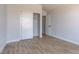 Light bedroom with wood-look floors and sliding closet doors, creating a clean and inviting space at 887 Cozy Valley St, Henderson, NV 89015