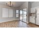 Open dining area with modern light fixture, sliding glass door to backyard at 887 Cozy Valley St, Henderson, NV 89015