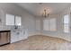 Light-filled dining area featuring modern chandelier, ample natural light and wood-look flooring at 887 Cozy Valley St, Henderson, NV 89015