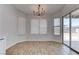 Bright dining area featuring modern lighting and a sliding glass door to the backyard at 887 Cozy Valley St, Henderson, NV 89015