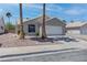 Single story home with a 2 car garage, xeriscaped front yard, and tile roof at 887 Cozy Valley St, Henderson, NV 89015