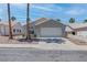 Charming single-story home with a two-car garage and xeriscaped front yard at 887 Cozy Valley St, Henderson, NV 89015