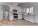 Bright kitchen features stainless steel appliances, white cabinets, and stylish backsplash at 887 Cozy Valley St, Henderson, NV 89015