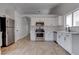 Modern kitchen with stainless steel appliances, white cabinets, and decorative backsplash at 887 Cozy Valley St, Henderson, NV 89015