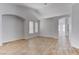 A bright and airy living room featuring wood-look tile flooring and neutral wall colors at 887 Cozy Valley St, Henderson, NV 89015