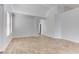 Open living room with wood look tile flooring and arched doorways leading to the kitchen and bedroom at 887 Cozy Valley St, Henderson, NV 89015