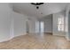 Living room with open floor plan, wood look tile flooring, and a ceiling fan at 887 Cozy Valley St, Henderson, NV 89015