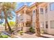 Inviting two-story condo with a private balcony and classic desert landscaping at 904 Boulder Springs Dr # 102, Las Vegas, NV 89128