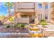 Inviting two-story condo featuring private balcony, desert landscaping, and convenient stair access at 904 Boulder Springs Dr # 102, Las Vegas, NV 89128