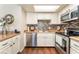 Well-maintained kitchen with white cabinets, stainless steel appliances, and modern backsplash at 904 Boulder Springs Dr # 102, Las Vegas, NV 89128