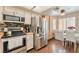 Modern kitchen features stainless steel appliances and warm wood floors, plus natural light from the windows at 904 Boulder Springs Dr # 102, Las Vegas, NV 89128