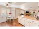 Bright eat-in kitchen with white cabinets, hardwood floors, a breakfast nook, and stainless steel refrigerator at 904 Boulder Springs Dr # 102, Las Vegas, NV 89128