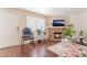 Inviting living area with a stone fireplace, wood floors, and natural light from the windows at 904 Boulder Springs Dr # 102, Las Vegas, NV 89128