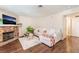 Bright living room features a stone fireplace, plush sofa, and wood flooring at 904 Boulder Springs Dr # 102, Las Vegas, NV 89128