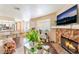 Inviting living area with fireplace and flatscreen TV, flowing into the kitchen with a bar at 904 Boulder Springs Dr # 102, Las Vegas, NV 89128