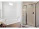 Bright bathroom featuring a tub and separate shower with glass doors at 909 Trinity Pond Cir, Henderson, NV 89002