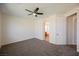 Spacious carpeted bedroom with overhead ceiling fan at 909 Trinity Pond Cir, Henderson, NV 89002