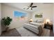 Bright bedroom with a large window, neutral colors, and comfortable furnishings at 909 Trinity Pond Cir, Henderson, NV 89002