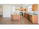 Spacious kitchen featuring a center island, wooden cabinets, and stainless steel appliances at 909 Trinity Pond Cir, Henderson, NV 89002