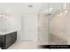 Modern bathroom with a glass enclosed shower featuring double shower heads and a dark vanity at 9101 Alta Dr # 102, Las Vegas, NV 89145