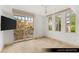 Bedroom with large glass sliding doors leading to a balcony overlooking tropical trees and buildings at 9101 Alta Dr # 102, Las Vegas, NV 89145