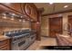 Gourmet kitchen featuring high-end stainless steel appliances, custom cabinetry, and granite countertops at 9101 Alta Dr # 102, Las Vegas, NV 89145