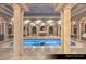 Luxurious men's jacuzzi with water feature, stone arches, columns and decorative tile at 9101 Alta Dr # 102, Las Vegas, NV 89145