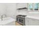 Close up shot of the kitchen with stainless steel appliances and white cabinets at 9101 Alta Dr # 102, Las Vegas, NV 89145