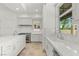 Bright kitchen features white cabinets, stone floors, and stainless steel appliances at 9101 Alta Dr # 102, Las Vegas, NV 89145
