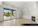 Open living room features built in shelving, fireplace, and patio doors to exterior at 9101 Alta Dr # 102, Las Vegas, NV 89145