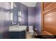 Elegant powder room featuring stylish wallpaper and modern fixtures at 9101 Alta Dr # 102, Las Vegas, NV 89145