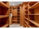 View of the wooden shelving within the primary walk-in closet at 9101 Alta Dr # 102, Las Vegas, NV 89145