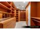 Large primary closet features wood shelving, drawers, and racks at 9101 Alta Dr # 102, Las Vegas, NV 89145