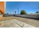 A view of an empty backyard with a block wall and an area of concrete at 929 Center St, Henderson, NV 89015