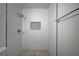 Shower with white subway tile surround, mosaic tile floor and niche detail at 929 Center St, Henderson, NV 89015