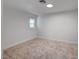 Bright bedroom with neutral carpet, white walls, and natural light from the window at 929 Center St, Henderson, NV 89015