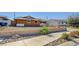 Charming single-story home with an expansive driveway, xeriscaping, and lush landscaping at 929 Center St, Henderson, NV 89015