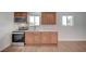 Efficient kitchen has stainless steel stove, microwave, sink and wooden cabinets at 929 Center St, Henderson, NV 89015