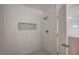 Contemporary shower with white subway tile, decorative niche and mosaic tile flooring at 929 Center St, Henderson, NV 89015