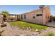 Cozy backyard with small patch of grass, desert landscaping, and covered patio at 945 Stetson Dr, Henderson, NV 89002