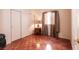 Cozy bedroom with hardwood floors, a window with curtains, and a closet at 945 Stetson Dr, Henderson, NV 89002