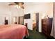 Bedroom featuring a ceiling fan, and an open door leading to an en-suite bathroom at 945 Stetson Dr, Henderson, NV 89002