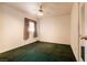 A carpeted bedroom featuring a ceiling fan and window with curtains at 945 Stetson Dr, Henderson, NV 89002